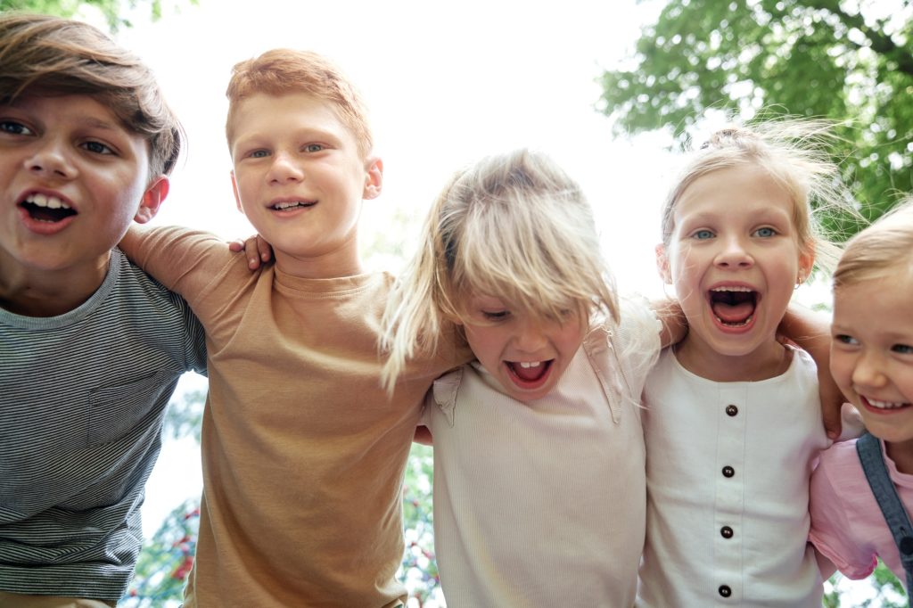Close up of group of kids embracing together
