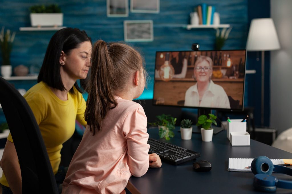 Mother and daughter using video call conference